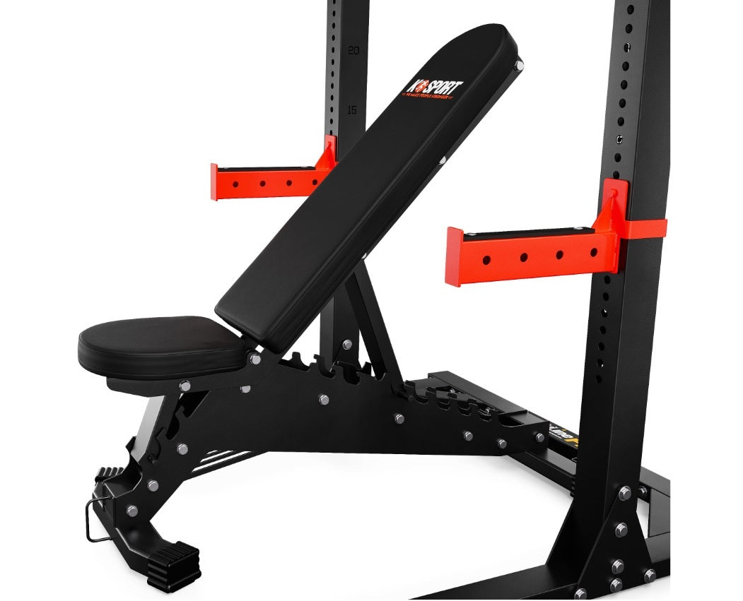 Black weight bench with red padding on a white background