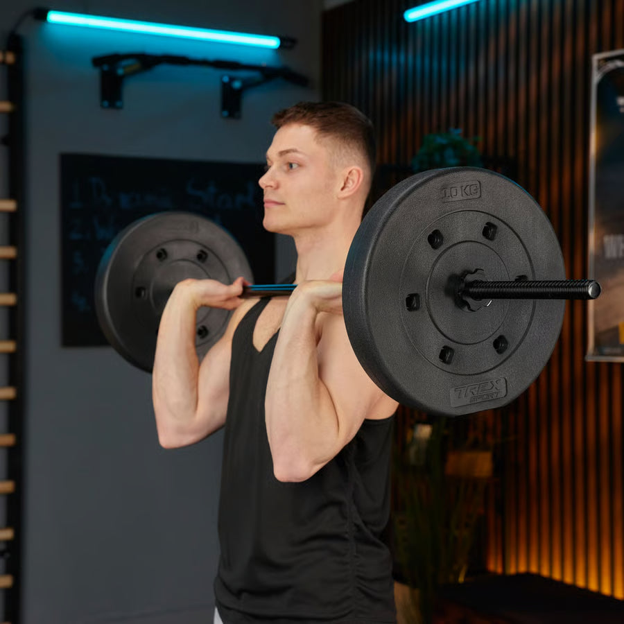 Man lifting a barbell in a gym setting