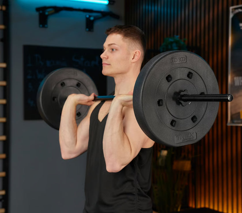 Man lifting a barbell in a gym setting