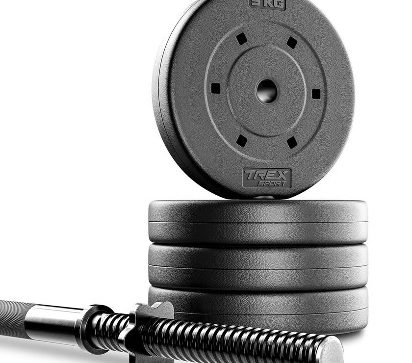 Stack of weight plates with a barbell on a white background