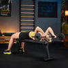 Woman performing a barbell exercise in a home gym setting.