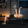Woman lifting a barbell on a bench in a gym setting with motivational posters.