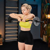 Woman lifting a barbell in a gym setting