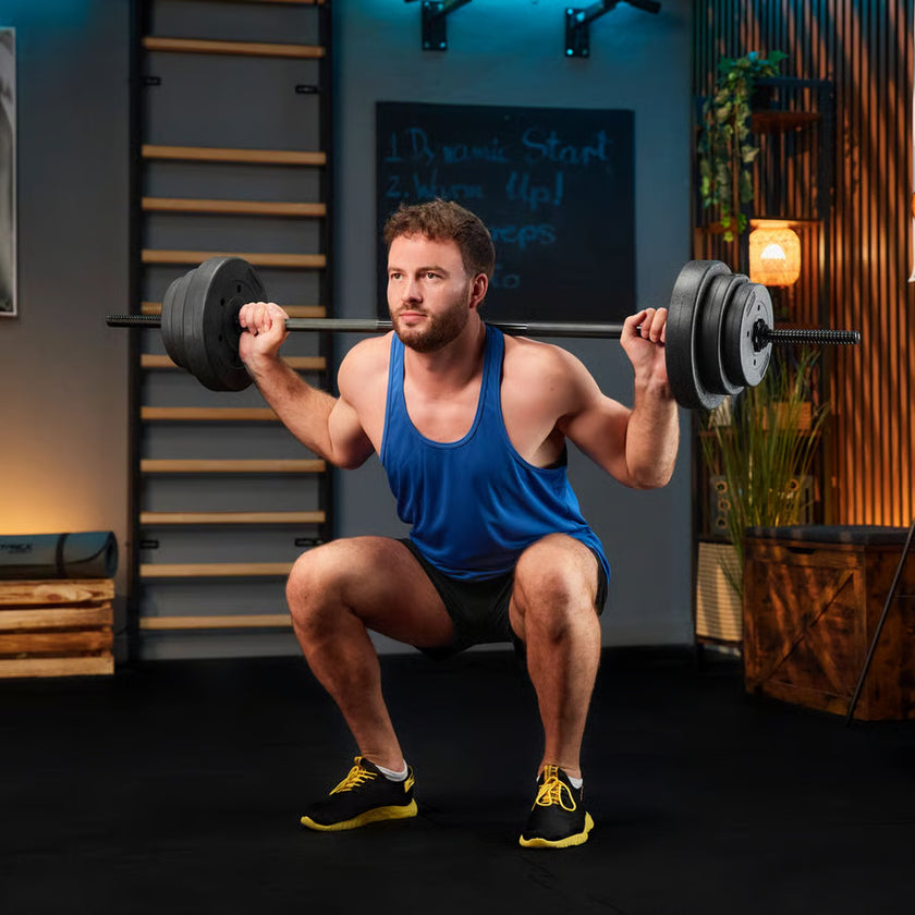 Man in a blue tank top lifting weights in a gym setting