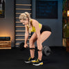 Woman lifting weights in a gym setting